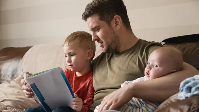 Male Foster Carer Reading Story Gettyimages 1051328308