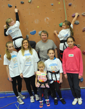 A fostering family have fun on a climbing wall